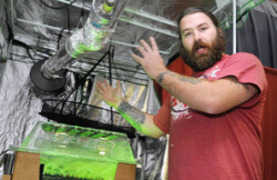 McClure, of the Medical Marijuana Caregivers of Maine, talks about indoor growing equipment in the Maine Hydroponics Supply booth during the Home Grown Maine trade show Saturday at the Augusta Civic Center. (Photo by Joe Phelan)
